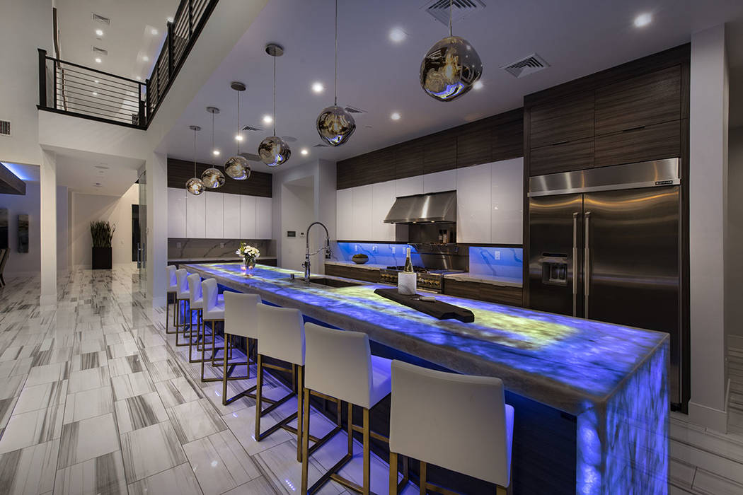 The gourmet Jenn-Air Pro kitchen features Onyx under light waterfall counter tops. (Synergy Sot ...