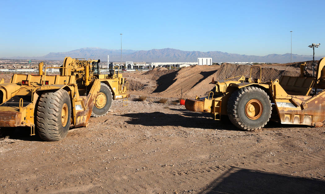 Heavy construction equipment is seen at an apartment complex project site near the Buffalo Driv ...