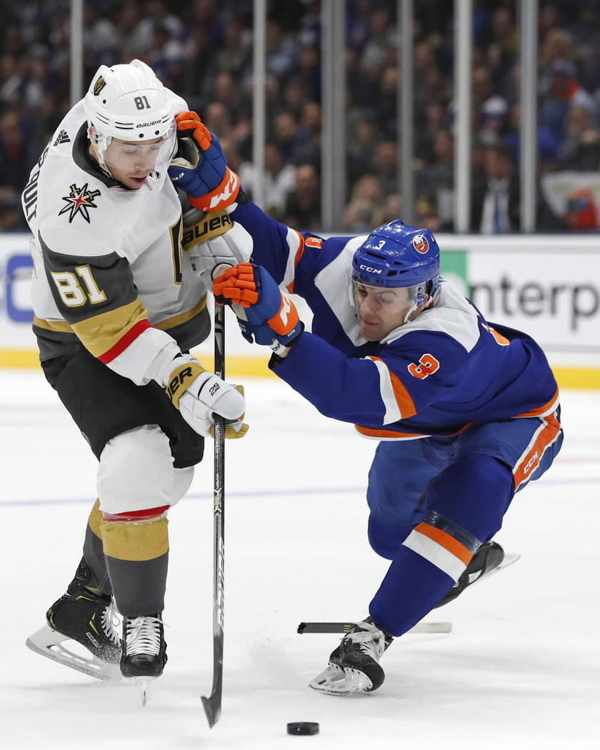New York Islanders defenseman Adam Pelech (3) holds on to Vegas Golden Knights center Jonathan ...