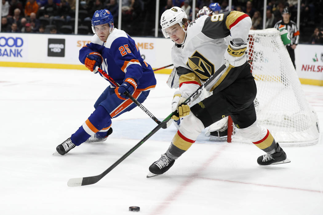 New York Islanders defenseman Devon Toews (25) and Vegas Golden Knights center Cody Glass (9) g ...