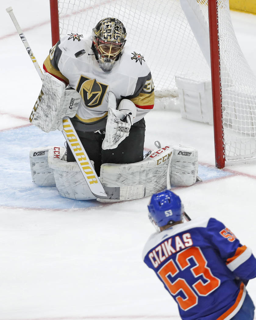 A shot by New York Islanders center Casey Cizikas (53) bounces near the chin of Vegas Golden Kn ...