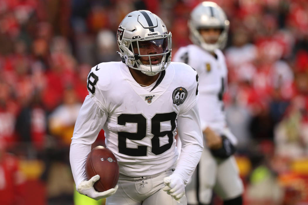 Oakland Raiders running back Josh Jacobs (28) holds on to the football after a run during the f ...