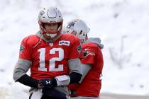 New England Patriots quarterback Tom Brady (12) warms up during an NFL football practice, Wedne ...
