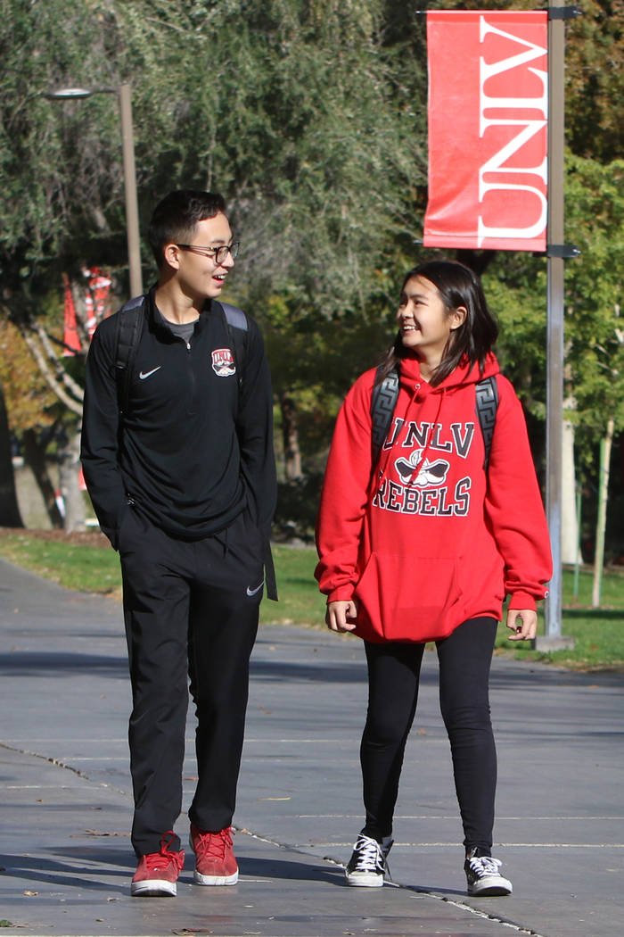 Shenlone Wu, 12, and his sister Shenmei, 13, both full-time students at UNLV, walk along a side ...