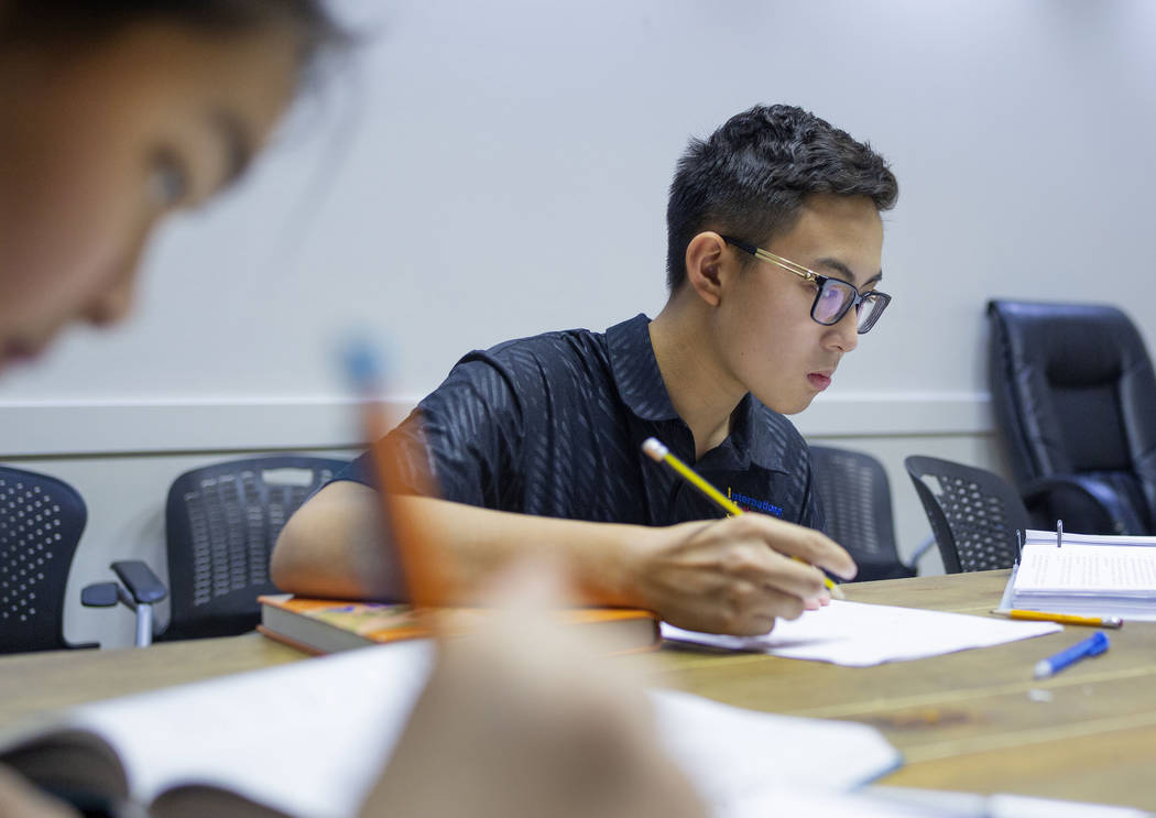 UNLV students Shenmei Wu, 13, left, and Shenlone Wu, 12, work on math proofs for fun at their p ...
