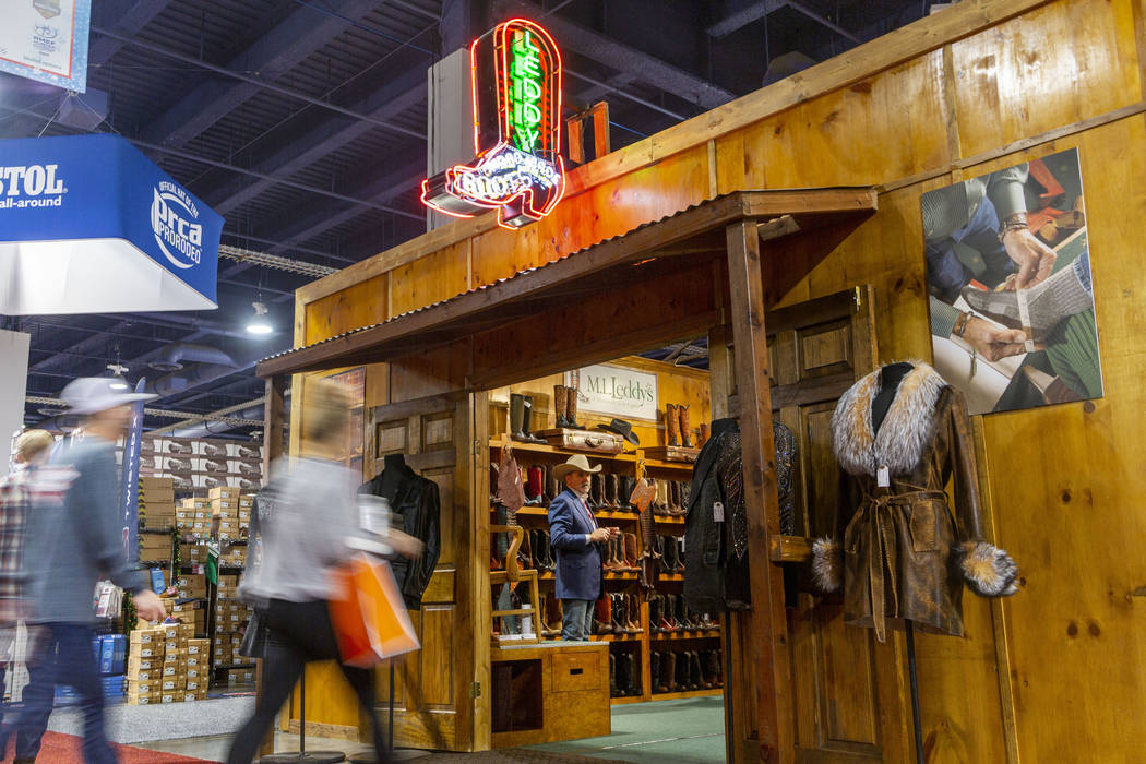 Individuals enter the M.L. Leddy's booth at Cowboy Christmas at the Las Vegas Convention Center ...