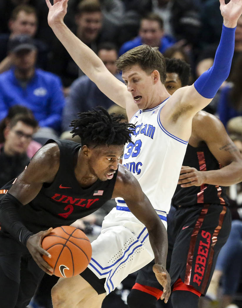 UNLV forward Donnie Tillman (2) fouls BYU forward Dalton Nixon (33) during the second half of a ...