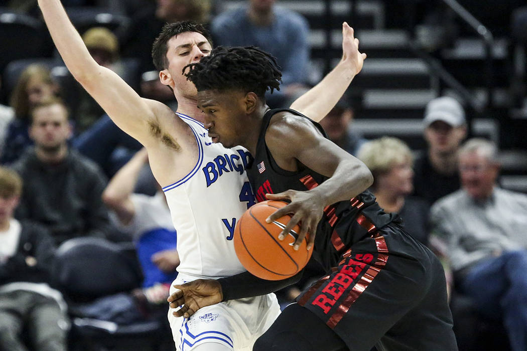 UNLV forward Donnie Tillman, right, drives into BYU guard Alex Barcello (4) during the second h ...