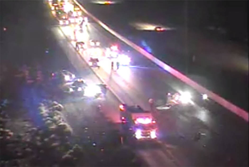 First responders work at the scene of a crash in the southbound lanes of Interstate 15 near Jea ...