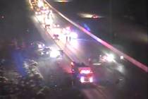 First responders work at the scene of a crash in the southbound lanes of Interstate 15 near Jea ...