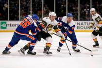 New York Islanders defenseman Johnny Boychuk (55) and right wing Leo Komarov (47) surround Vega ...