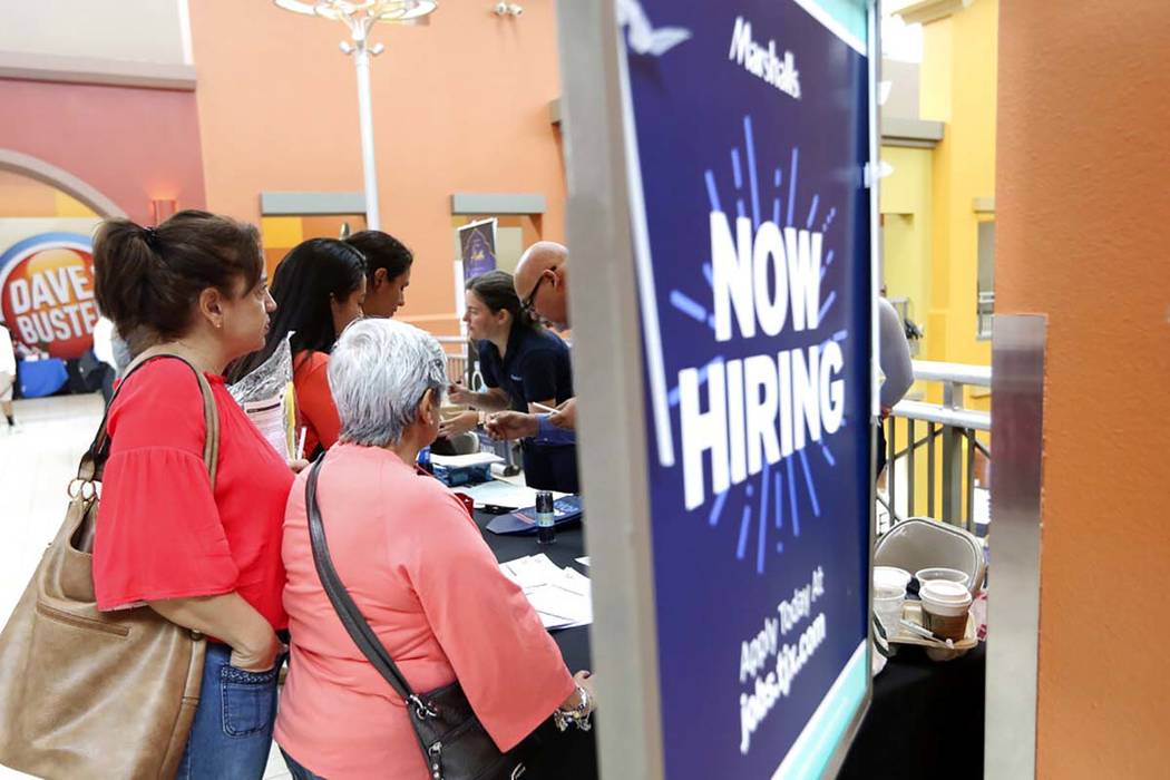 In a Oct. 1, 2019, file photo, people wait in line to inquire about job openings with Marshalls ...