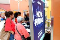 In a Oct. 1, 2019, file photo, people wait in line to inquire about job openings with Marshalls ...