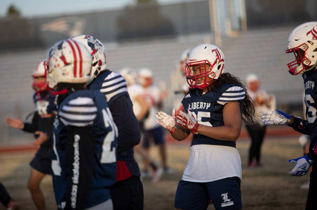 Liberty's inside linebacker Malachi Maika-Lepisi Asuega, right, claps as the team moves on from ...