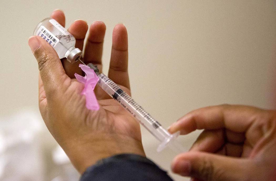 In a Feb. 7, 2018, file photo, a nurse prepares a flu shot at the Salvation Army in Atlanta. Th ...