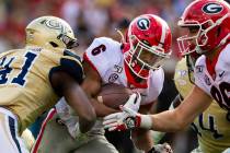 Georgia running back Kenny McIntosh runs with Georgia Tech defensive lineman Jaquan Henderson ( ...