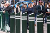 People walk past safety bollards on the Vegas Strip. (Las Vegas Review-Journal)