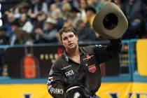 Tyler Waguespack of Gonzales, La., celebrates after taking the best score in the steer wrestlin ...