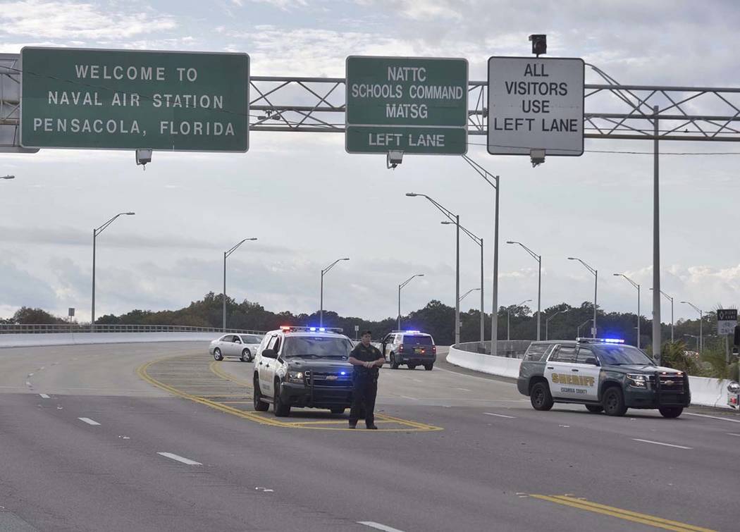 Police vehicles block the entrance to the Pensacola Air Base, Friday, Dec. 6, 2019 in Pensacola ...