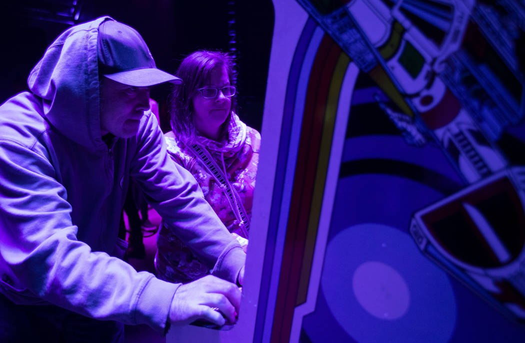 Derek McCaughey, left and Sarah Holeton, right, play a game in the arcade at Intersect Festival ...
