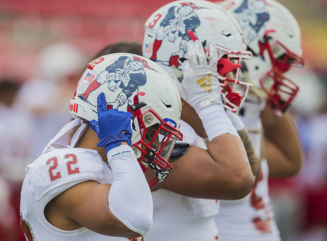 Liberty senior safety Trey Cain (22) straps on his helmet before the start of the Patriots Clas ...