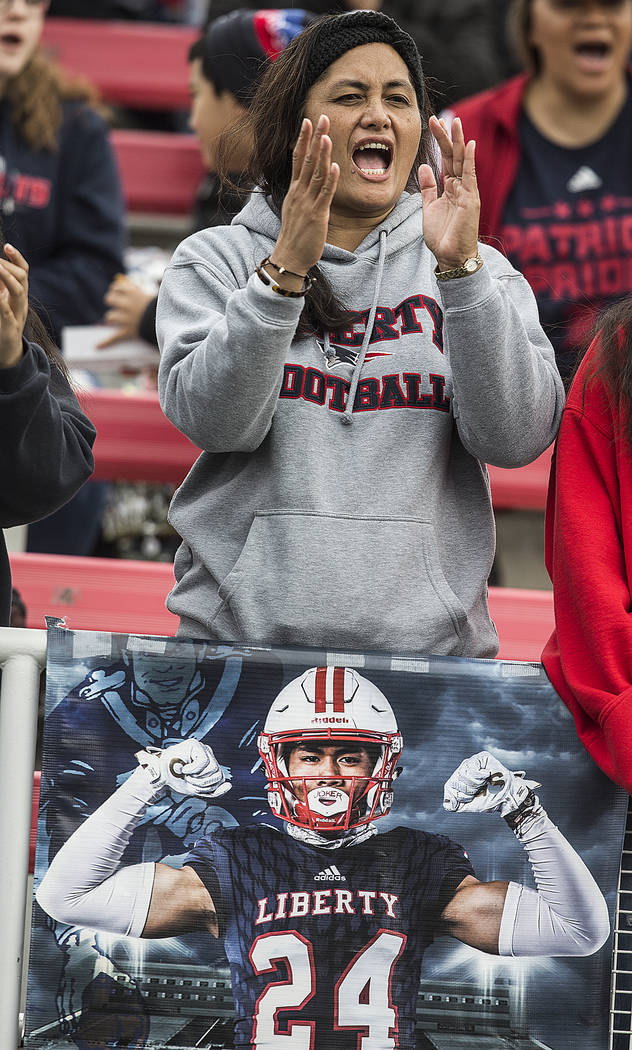 Liberty fans cheer for the Patriots during their Class 4A state football championship game agai ...