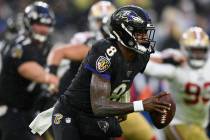 Baltimore Ravens quarterback Lamar Jackson (8) looks to pass the ball in the first half of an N ...