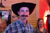 Ryder Young of Boise, Idaho, shows off his handlebar mustache while waiting among those in a lo ...