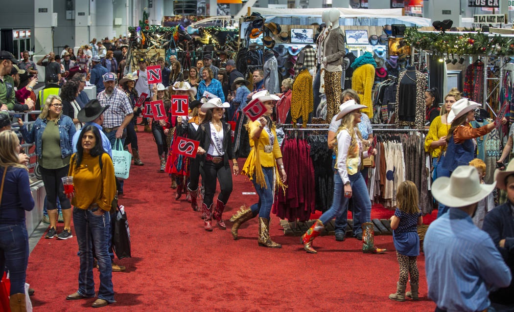 Contestants walk past the crowd in the Miss Rodeo America Justin Boot Parade during Cowboy Chri ...