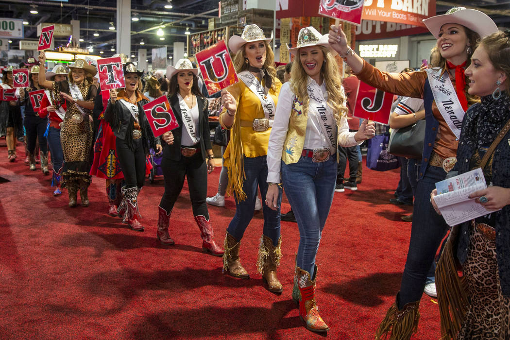 Contestants chant and walk in the Miss Rodeo America Justin Boot Parade during Cowboy Christmas ...