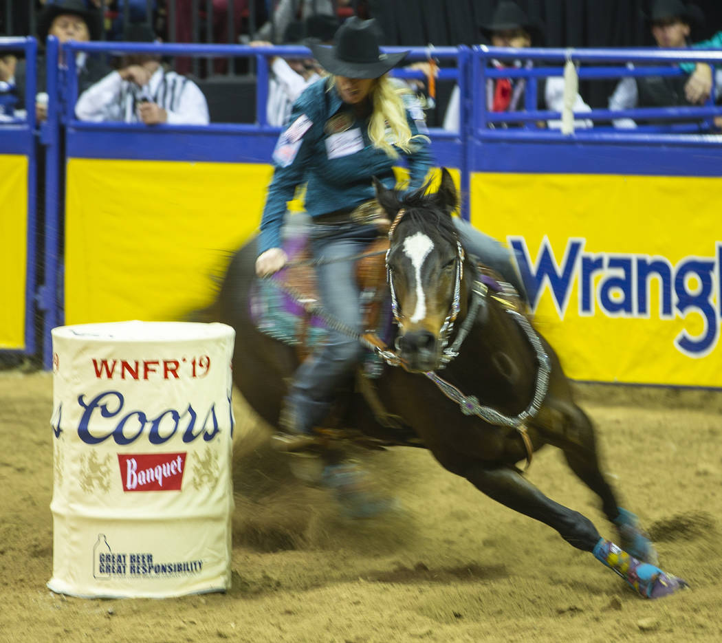 Amberleigh Moore of Salem, Oregon, navigates another barrel while taking first place in Barrel ...
