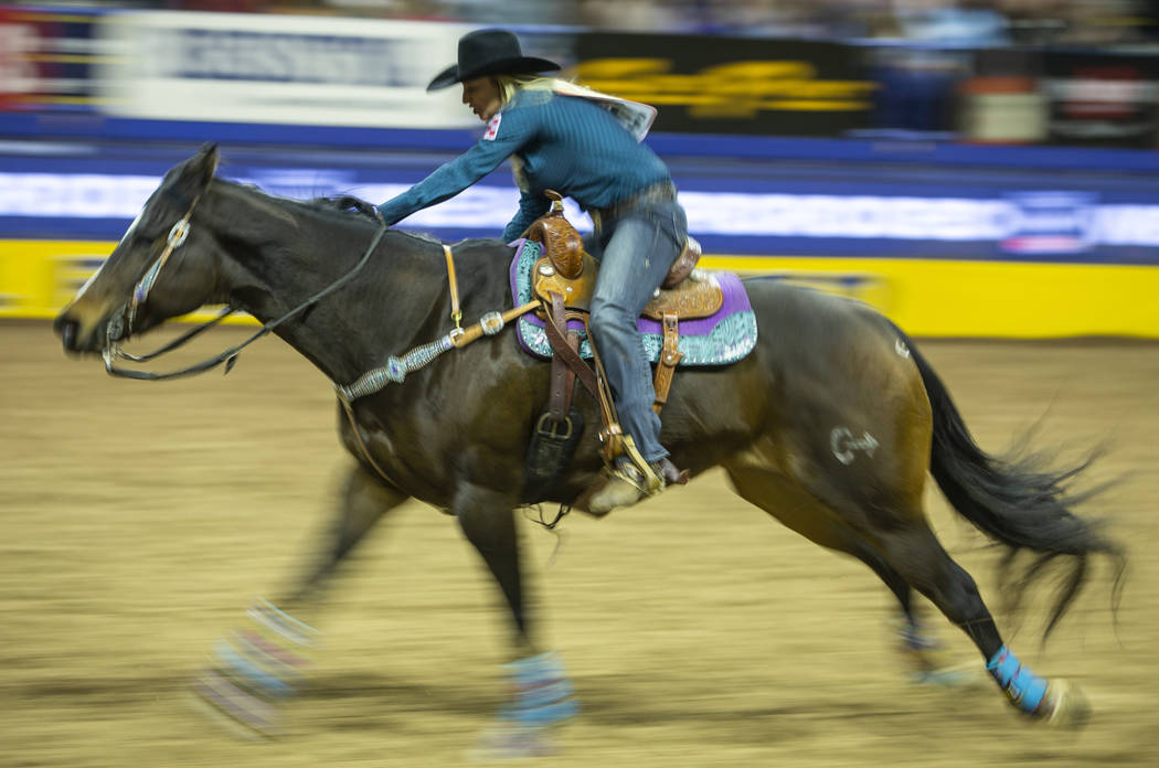 Amberleigh Moore of Salem, Oregon, heads home while taking first place in Barrel Racing with a ...