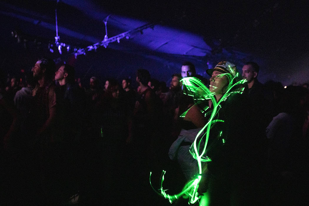 Amber Parucha of Las Vegas dances with an LED light whip as Toro Y Moi performs on Saturday, De ...