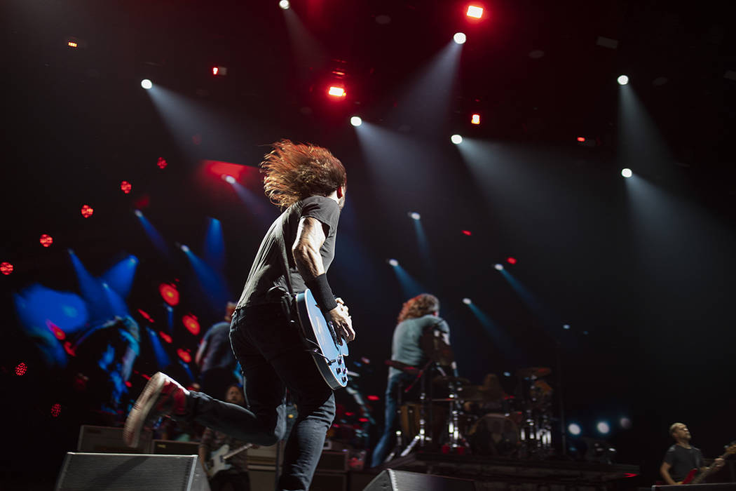 Dave Grohl of the Foot Fighters runs across the stage during their set on Saturday, Dec. 7, 201 ...