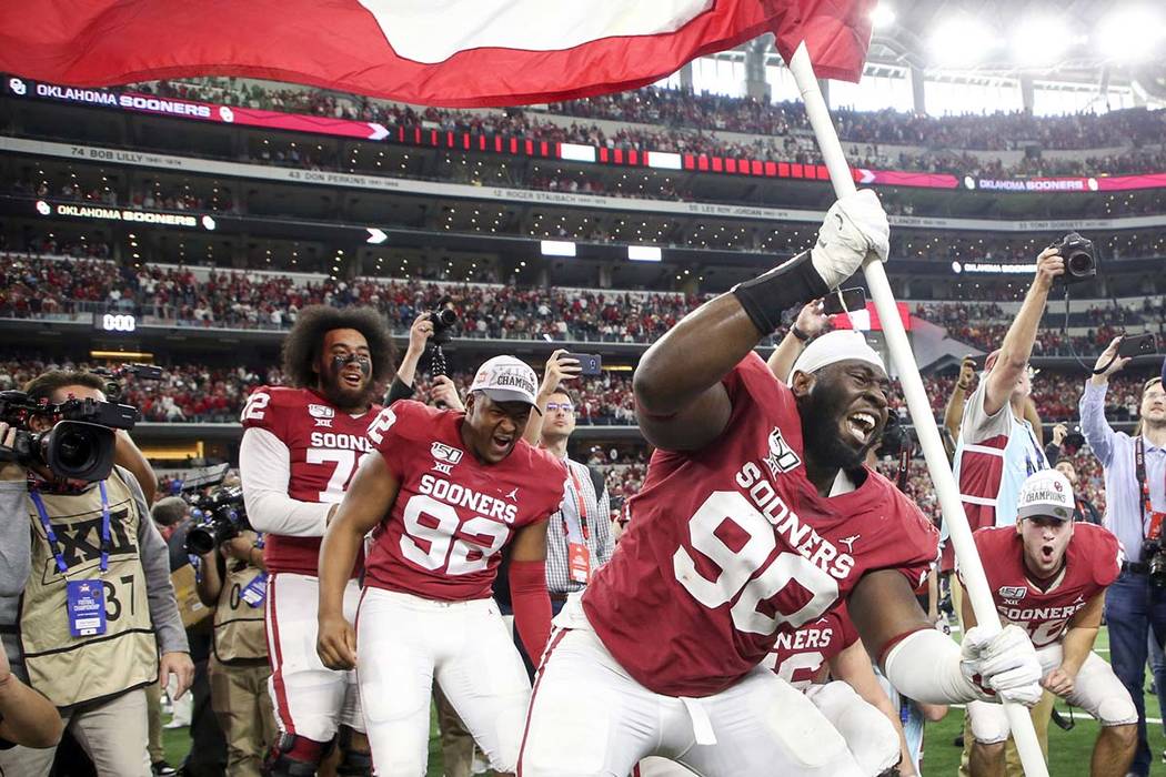 Oklahoma defensive lineman Neville Gallimore (90) plants a University of Oklahoma flag after th ...