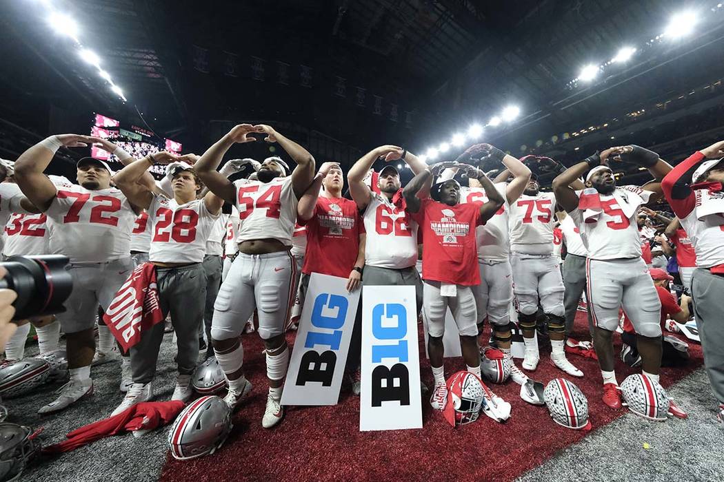 Ohio State players celebrate the team's 34-21 win over Wisconsin in the Big Ten championship NC ...