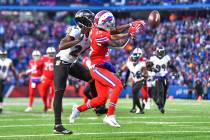 Baltimore Ravens cornerback Marcus Peters (24) breaks up a pass intended for Buffalo Bills wide ...