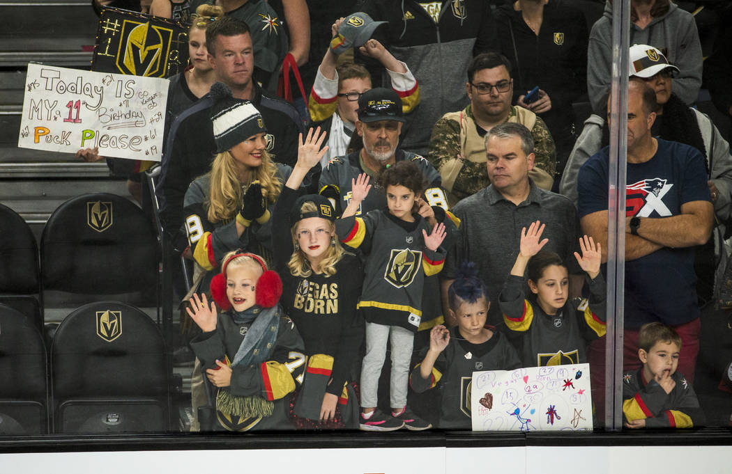 Vegas Golden Knights fans press up to the glass in hopes of getting a puck before the first per ...