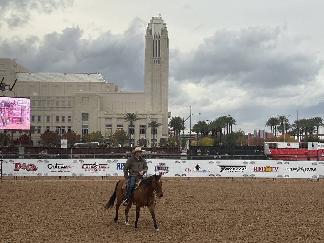 A man on horseback is shown at Core Arena with the Smith Center for the Performing Arts' bell t ...