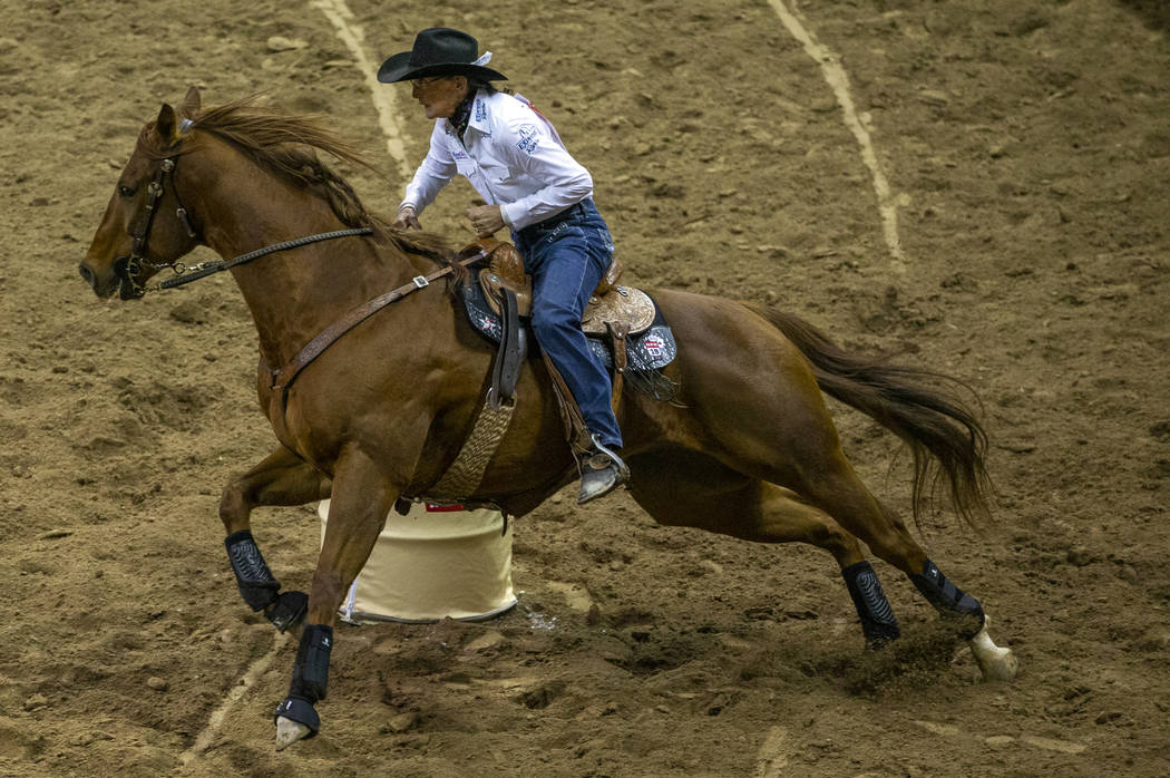 Dona Kay Rule of Minco, Okla., navigates the course in Barrel Racing during the fourth go round ...