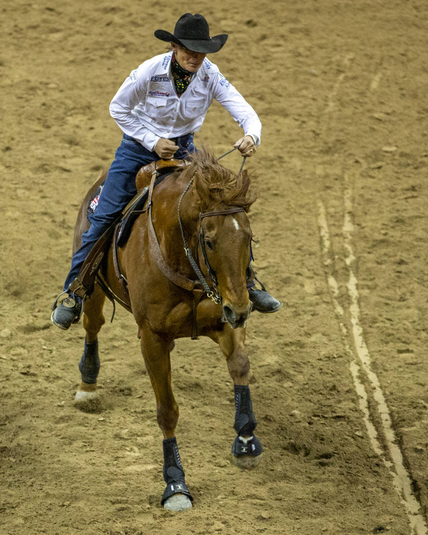 Dona Kay Rule of Minco, Okla., drives her horse on home in Barrel Racing during the fourth go r ...