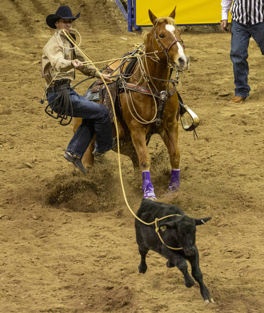 Shane Hanchey of Sulphur, La., looks to his calf before scoring a time of 7.50 seconds and a fi ...