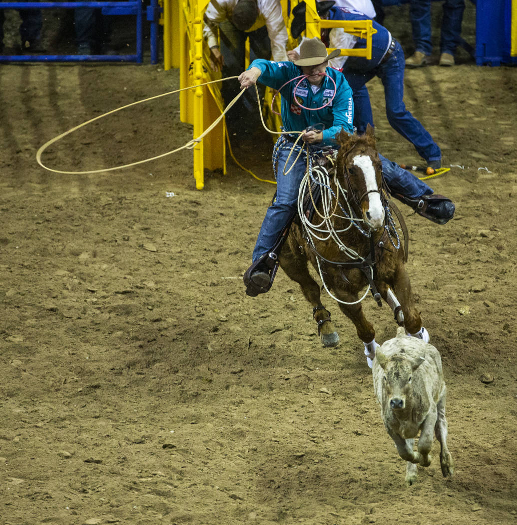 Tuf Cooper of Decatur, Texas, bears down on his calf in Tie-Down Roping during the fourth go ro ...