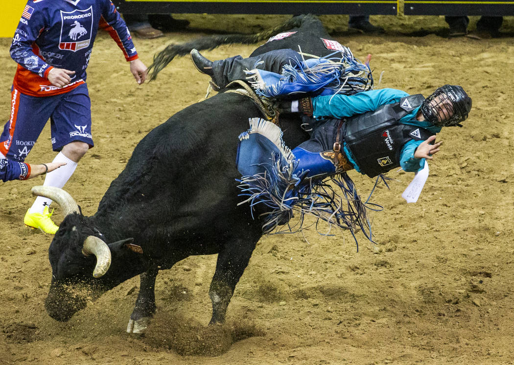 Tyler Bingham of Honeyville, Utah, gets sideways on Night Moves in Bull Riding during the fourt ...