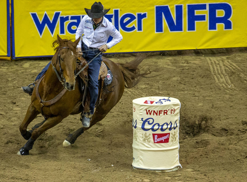Dona Kay Rule of Minco, Okla., navigates the course in Barrel Racing during the fourth go round ...