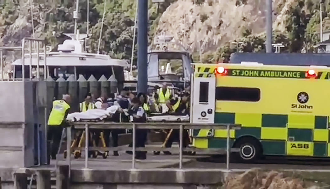 In this image made from video, injured from White Island volcanic eruption are ferried into wai ...