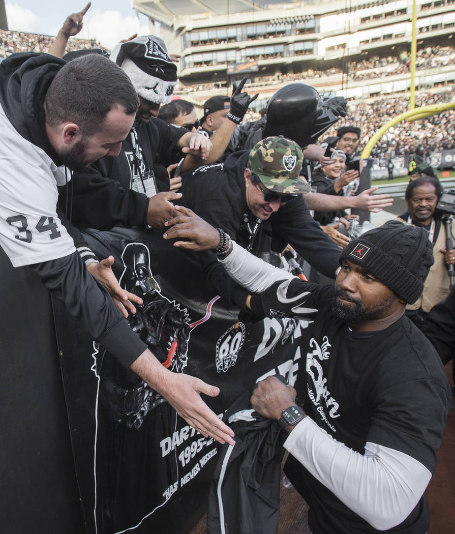 Oakland Raiders NFL Hall of Fame player Charles Woodson shakes hands with fans in the fourth qu ...