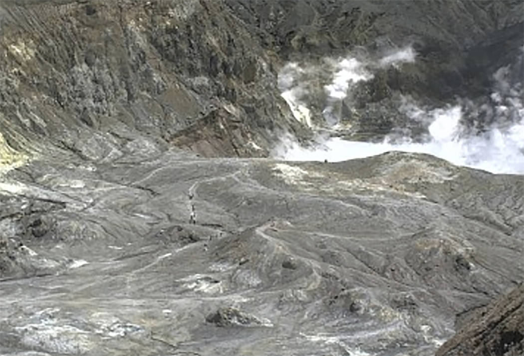 In this image released by GeoNet, tourists can be seen on a trail near the volcano's crater Mon ...