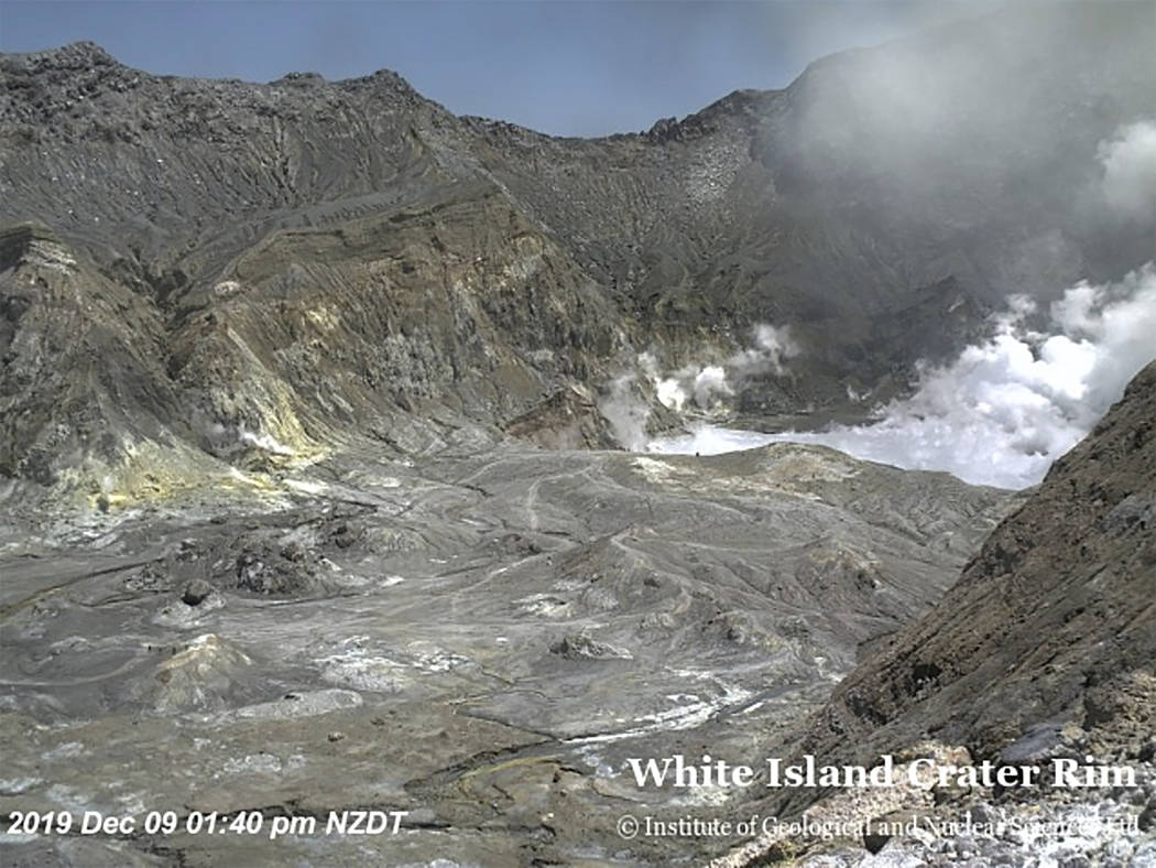 In this image released by GeoNet, tourists can be seen near the volcano's crater Monday, Dec. 9 ...