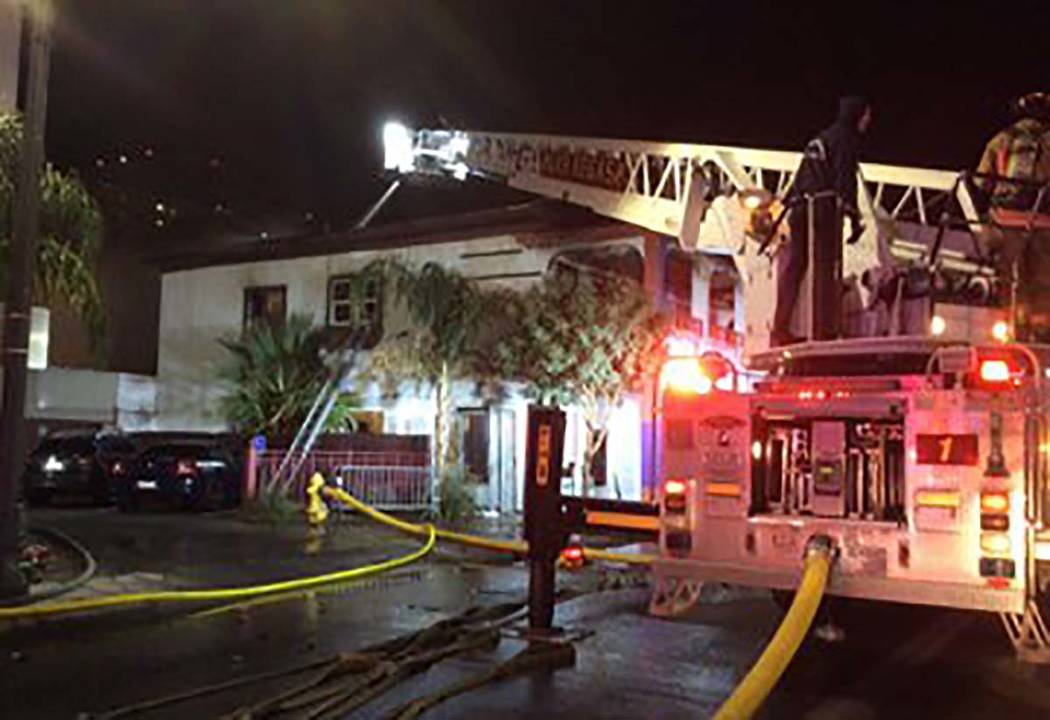 Firefighters battle a two-alarm blaze in a vacant building at 307 S. Main St. early Monday, Dec ...